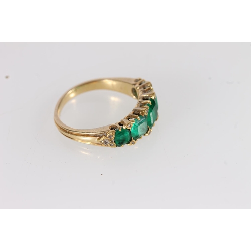 106 - Victorian yellow gold ring set with five graduating square cut emeralds, interspersed with rose cut ... 