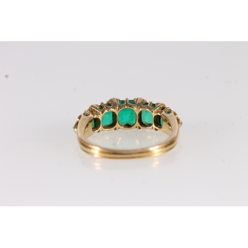 106 - Victorian yellow gold ring set with five graduating square cut emeralds, interspersed with rose cut ... 