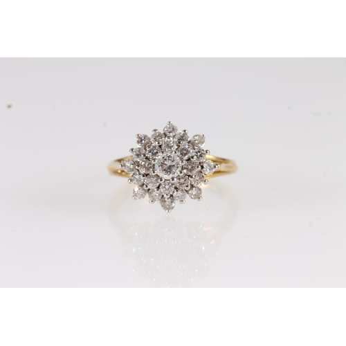 112 - 18ct gold diamond cluster ring, the round brilliant cut diamonds in a tiered flower head basket sett... 