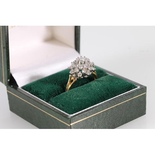 112 - 18ct gold diamond cluster ring, the round brilliant cut diamonds in a tiered flower head basket sett... 