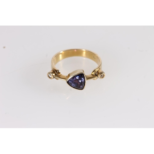 113 - Modernist 18ct gold amethyst and diamond ring, the trilliant cut amethyst on a knife edge mount flan... 