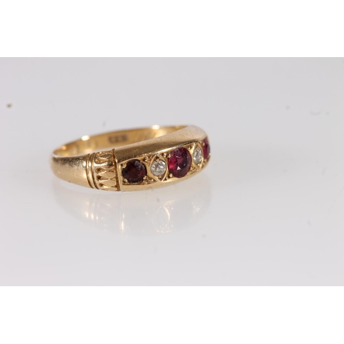 115 - Edwardian 18ct gold ruby and white stone ring, the three round cut rubies interspersed with two smal... 