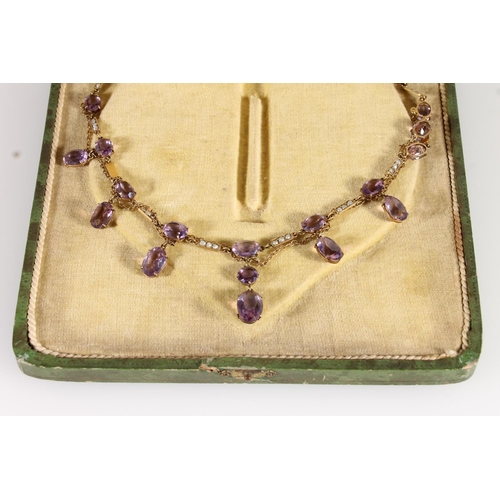 119 - Edwardian amethyst and split pearl necklace, the oval and round cut amethysts suspended on a fine ye... 