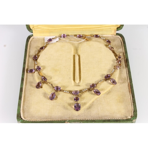 119 - Edwardian amethyst and split pearl necklace, the oval and round cut amethysts suspended on a fine ye... 