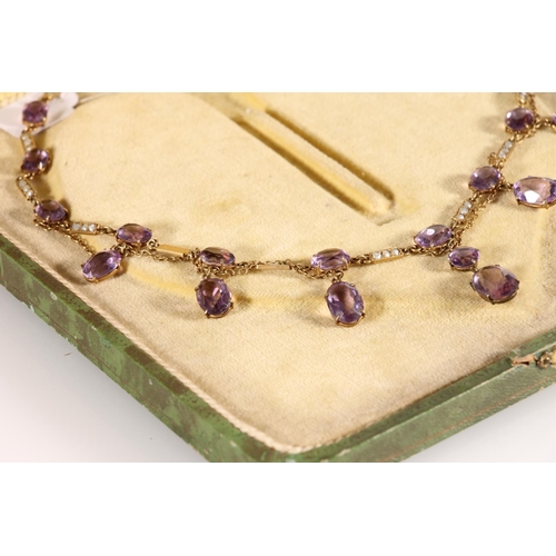 119 - Edwardian amethyst and split pearl necklace, the oval and round cut amethysts suspended on a fine ye... 