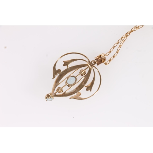 126 - Edwardian Art Nouveau 9ct gold and aquamarine lavaliere pendant, the open work scrolled gold frame a... 