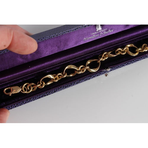 130 - 18ct gold fancy link bracelet with 9ct gold clasp, gross 41.7g, in purple Hamilton and Inches of Edi... 