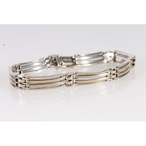 131 - 18ct white gold gate bracelet, the links with gilt wash finish, 21.6g, 20cm long.