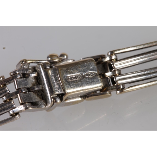 131 - 18ct white gold gate bracelet, the links with gilt wash finish, 21.6g, 20cm long.