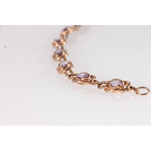 133 - Edwardian 9ct gold knotwork bracelet, set with oval amethyst coloured stones within double knotted l... 