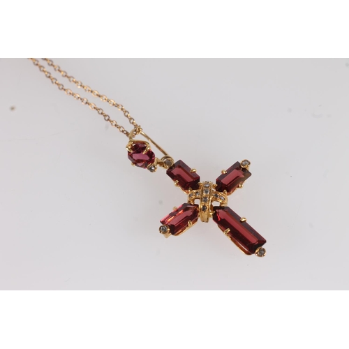 137 - Garnet set cross pendant, the rectangular cut garnets in cross form on a yellow metal mount interspe... 