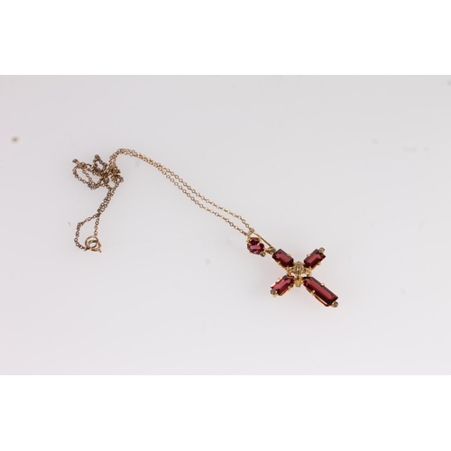 137 - Garnet set cross pendant, the rectangular cut garnets in cross form on a yellow metal mount interspe... 