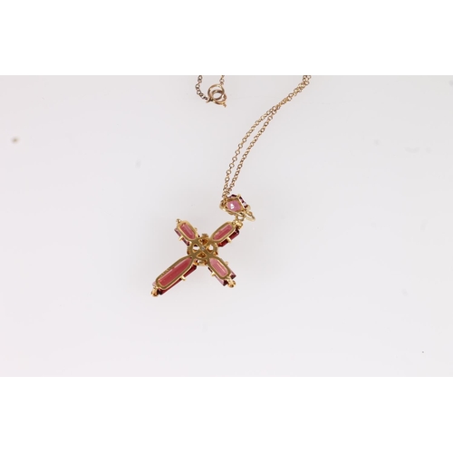 137 - Garnet set cross pendant, the rectangular cut garnets in cross form on a yellow metal mount interspe... 