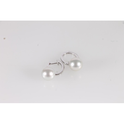 142 - 18ct white gold and pearl drop earrings, the hinged horseshoe shape earrings set with small diamonds... 