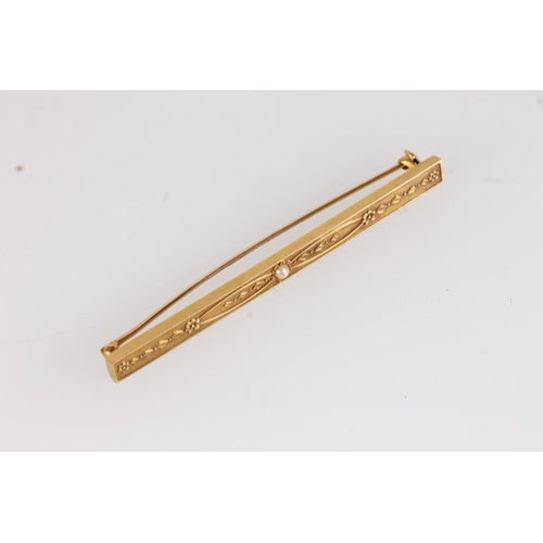 143 - Edwardian 9ct gold bar brooch, with central seed pearl within embossed floral design, 3.9g, W6.4cm.