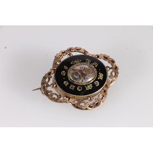 145 - Victorian mourning brooch, the central glazed panel holding a sprig of woven hair within black ename... 