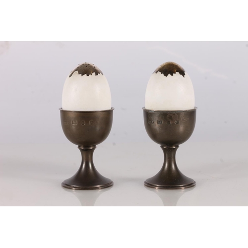 17 - Pair of silver salt and pepper pot egg cups by Anthony Gordon Elson, London, 1979, 11.5cm tall. (2)...
