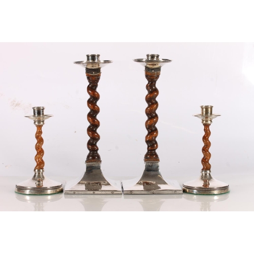 5 - Pair of silver and oak barley twist candlesticks by Albert Edward Jones, Birmingham, 1915 and a smal...