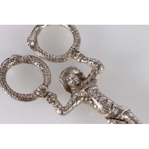 6 - Pair of silver candle snuffers or sugar nips in the form of a harlequin monkey gymnast on the rings,...