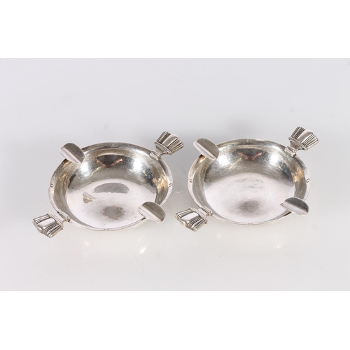 9 - Pair of silver ashtrays by Cecil R Walker, London, 1936, 153g gross, 12cm across the handles. (2)