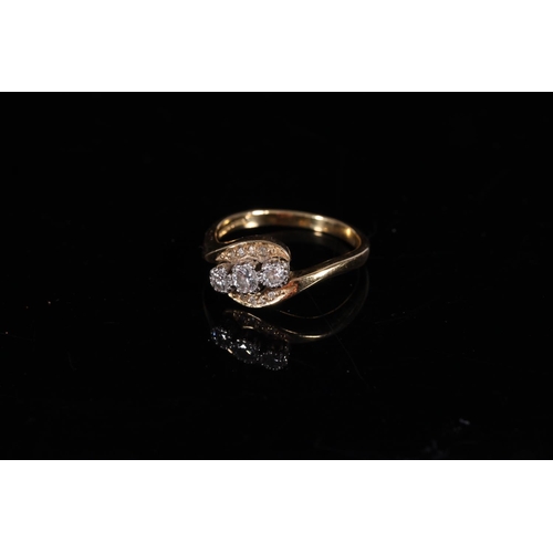 161 - 18ct gold diamond three stone ring in crossover setting, the stones approx. 0.1ct each, size R, 5g.