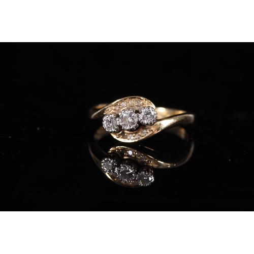 161 - 18ct gold diamond three stone ring in crossover setting, the stones approx. 0.1ct each, size R, 5g.