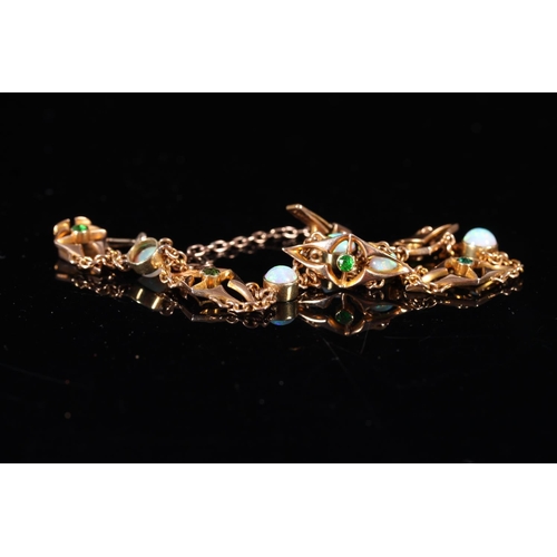 162 - 15ct gold bracelet set with opals and emeralds, 10g gross.