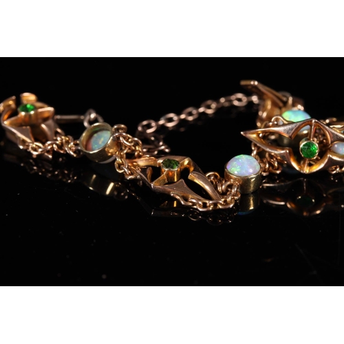 162 - 15ct gold bracelet set with opals and emeralds, 10g gross.