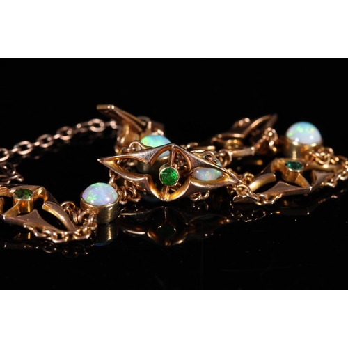 162 - 15ct gold bracelet set with opals and emeralds, 10g gross.