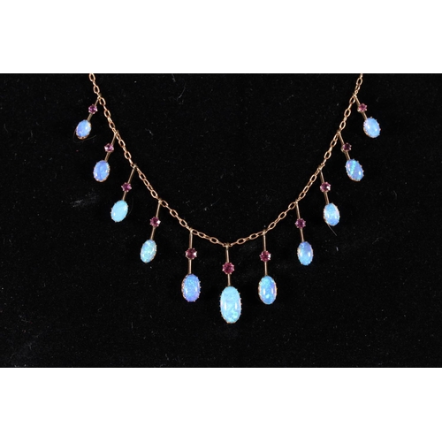 164 - 9ct gold opal and ruby pendant necklace having a fringe of eleven graduated suspended stones, 5.8g g... 