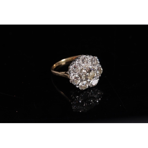 165 - Large diamond cluster ring of flower head form, the central 1.0ct stone encircled by seven 0.15-0.2c... 