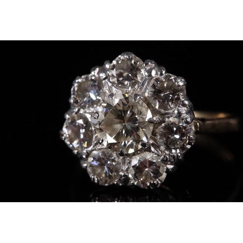 165 - Large diamond cluster ring of flower head form, the central 1.0ct stone encircled by seven 0.15-0.2c... 