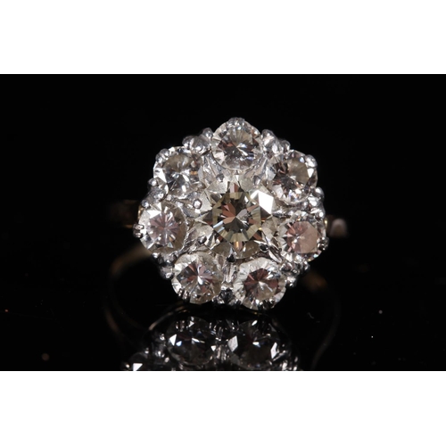 165 - Large diamond cluster ring of flower head form, the central 1.0ct stone encircled by seven 0.15-0.2c... 