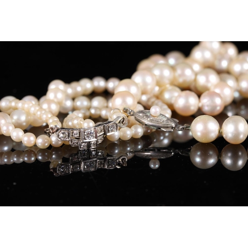 168 - Single strand pearl necklace with Art Deco style white metal closure set with diamonds, and a single... 