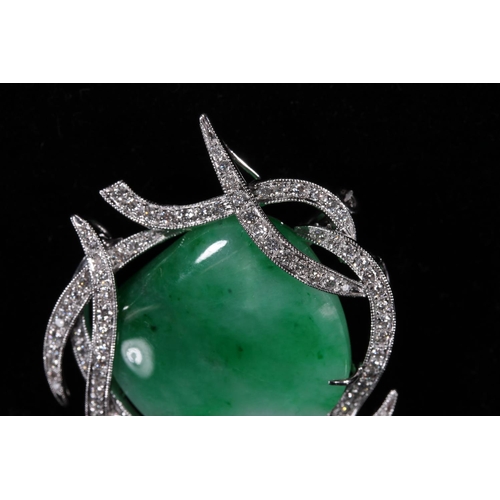 178 - Jade and diamond brooch, the irregular white green jade cabochon within a branched white metal mount... 