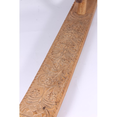 282 - Scandinavian folk art treen mangle board, 19th century, the flat board carved with foliate whorls an... 