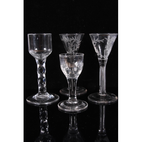 306 - Pair of George III wine glasses, c1770, the round funnel bowls engraved with wreaths on an air twist... 