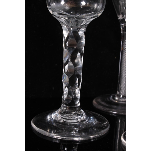 306 - Pair of George III wine glasses, c1770, the round funnel bowls engraved with wreaths on an air twist... 