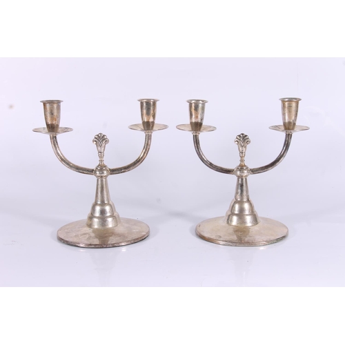 69 - Pair of Swedish Art Deco two branch weighted candlesticks, c1930s, of planished form with central sp... 