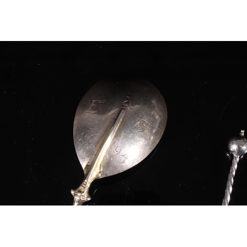 84 - Continental or English provincial silver love spoon, late 17th century, with scrolled mask head term... 