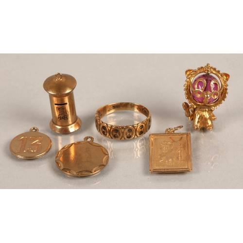 200 - Three 9ct gold charms (4.7g), another 9ct gold lion charm, yellow metal post box charm, and gold rin... 