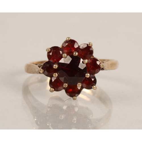 76 - 9ct gold ring set with cluster of ruby coloured gems, ring size M/N, 3g, 