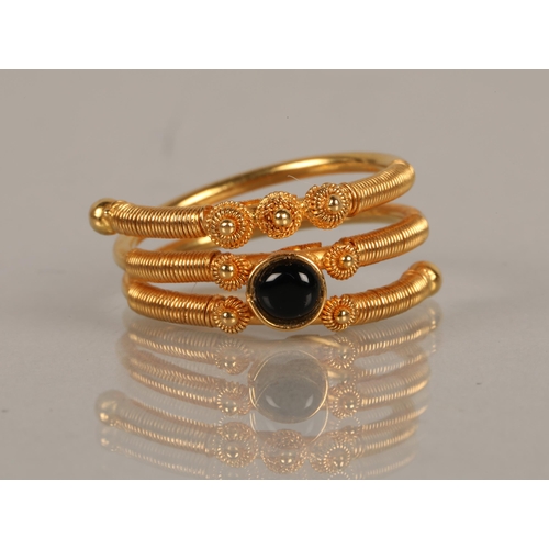 92 - High karat yellow gold ring set with a black gem, illegibly marked, 5.9g, ring size M/N