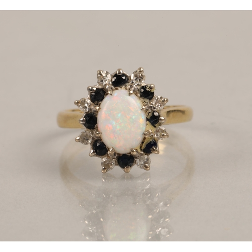 209 - Gold ring, marks illegible, set with an opal surrounded by diamonds and blue stones, ring size J, 3.... 