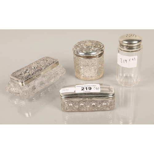 219 - Silver topped cut glass to include two trinket boxes, vanity jar and toiletry bottle, assorted hallm... 