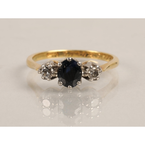 224 - 18ct gold ring set with a blue gem flanked by two diamonds, ring size Q