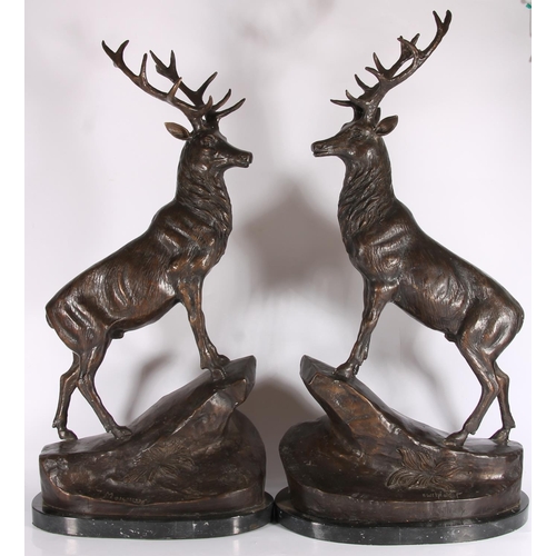 285 - After Jules Moigniez (French 1835-1894), a pair of hollow cast bronze stags on rocks, on variegated ... 