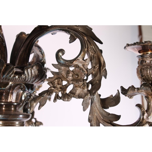 286 - Silver plated four branch figural candelabra centrepiece in a  Rococo design, the scrolling leaf and... 