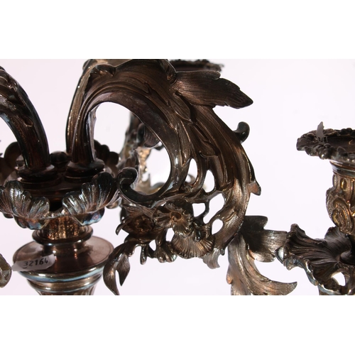 286 - Silver plated four branch figural candelabra centrepiece in a  Rococo design, the scrolling leaf and... 