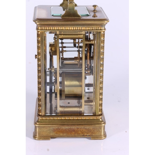 291 - French brass carriage clock, early 20th century, the corniche case around a fretwork slip, cream ena... 